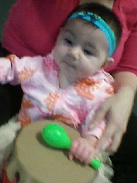 My 7-month-old daughter, Lizzie, shaking a maraca and banging a drum.
