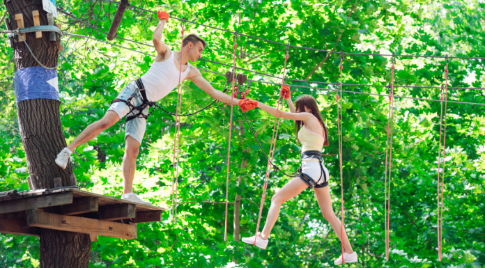 A couple completing a climbing rope course.