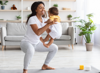 A woman working out with her baby.