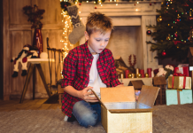 A boy opening Christmas presents.