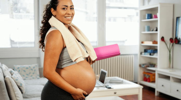 A woman exercising while pregnant.