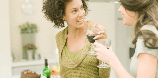Two women drinking wine.