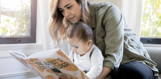 A mom reading a book to her baby.