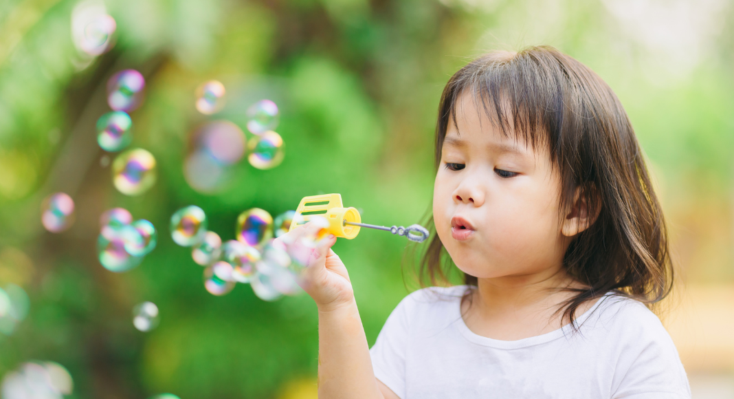 A girl blowing bubbles.