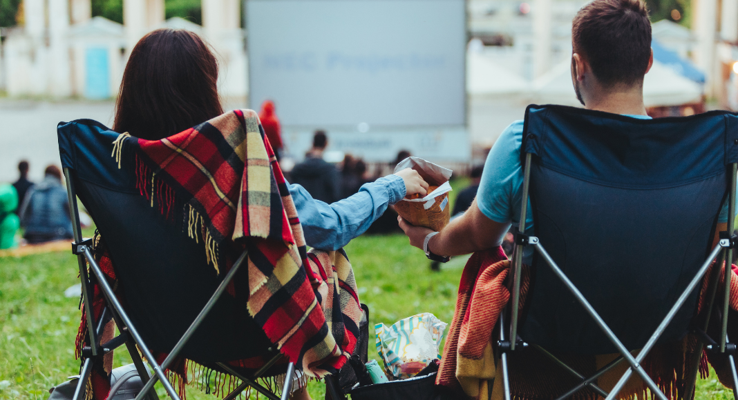 A couple at an outdoor movie.