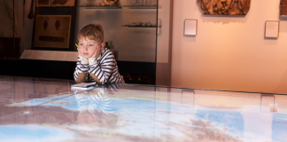 A boy looking at a museum exhibit.
