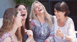 A group of four women laughing.