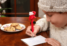 A little boy writing his holiday wish list.