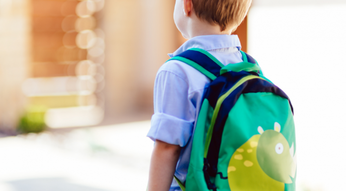 A kindergarten boy wearing a backpack.