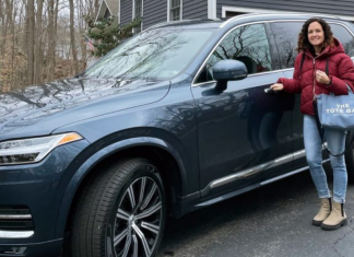 A woman standing next to her Volvo XC90
