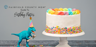 A birthday cake and toy dinosaur.