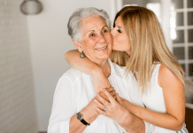 A woman kissing her grandmother.