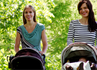 Two moms pushing strollers.