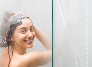 A woman washing her hair in the shower.