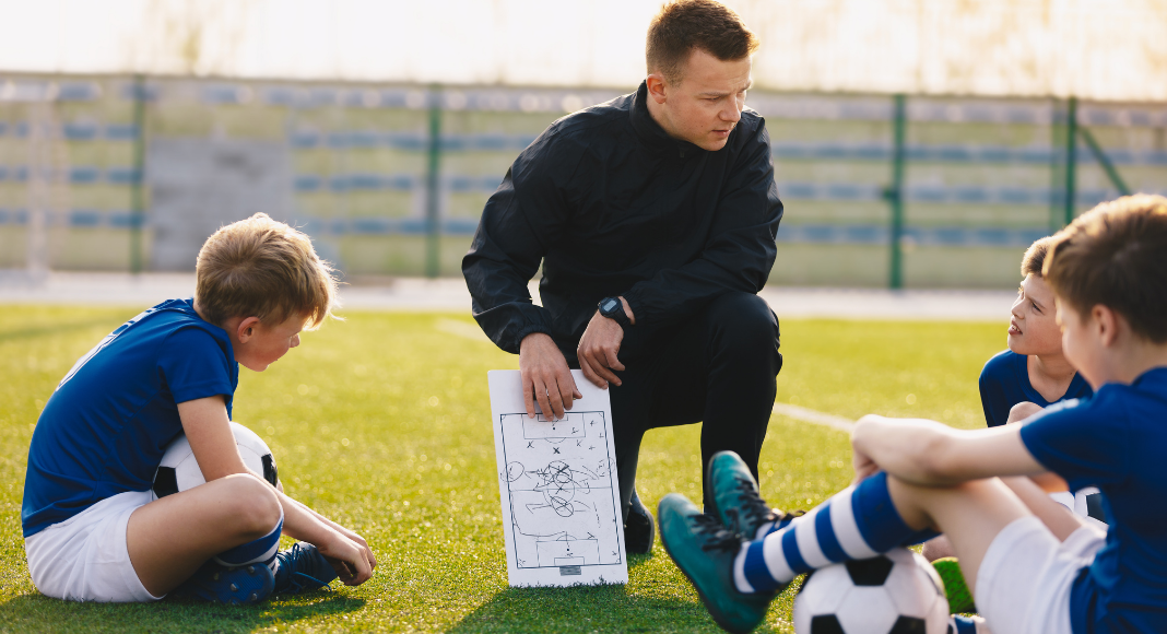 A soccer coach talking to his players.