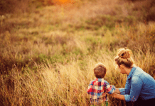 A mother in a field with her son.