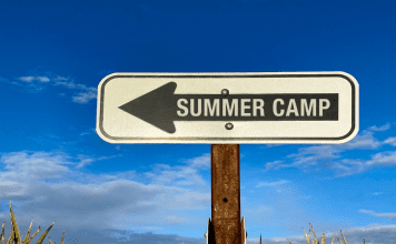 A sign pointing to summer camp.
