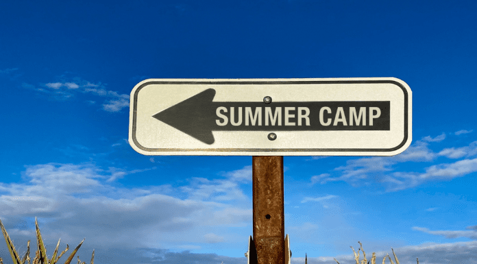 A sign pointing to summer camp.