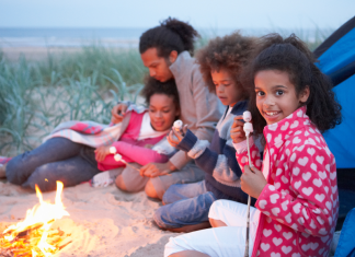 A family making S'mores on a camping trip.