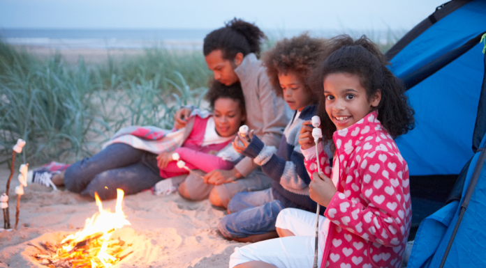 A family making S'mores on a camping trip.