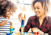 A mom playing blocks with her daughter