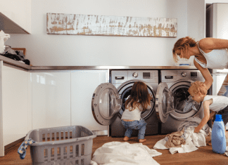 A mom doing laundry with her children.
