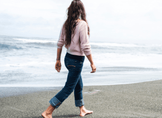 A woman walking on a beach.