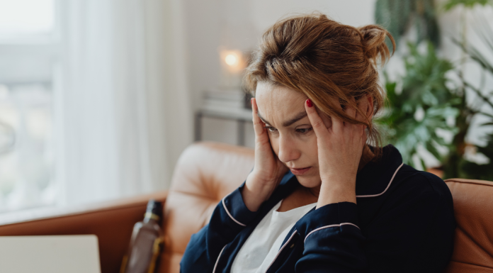 A stressed woman holding her head.