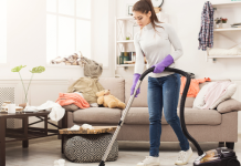 A woman cleaning a living room.