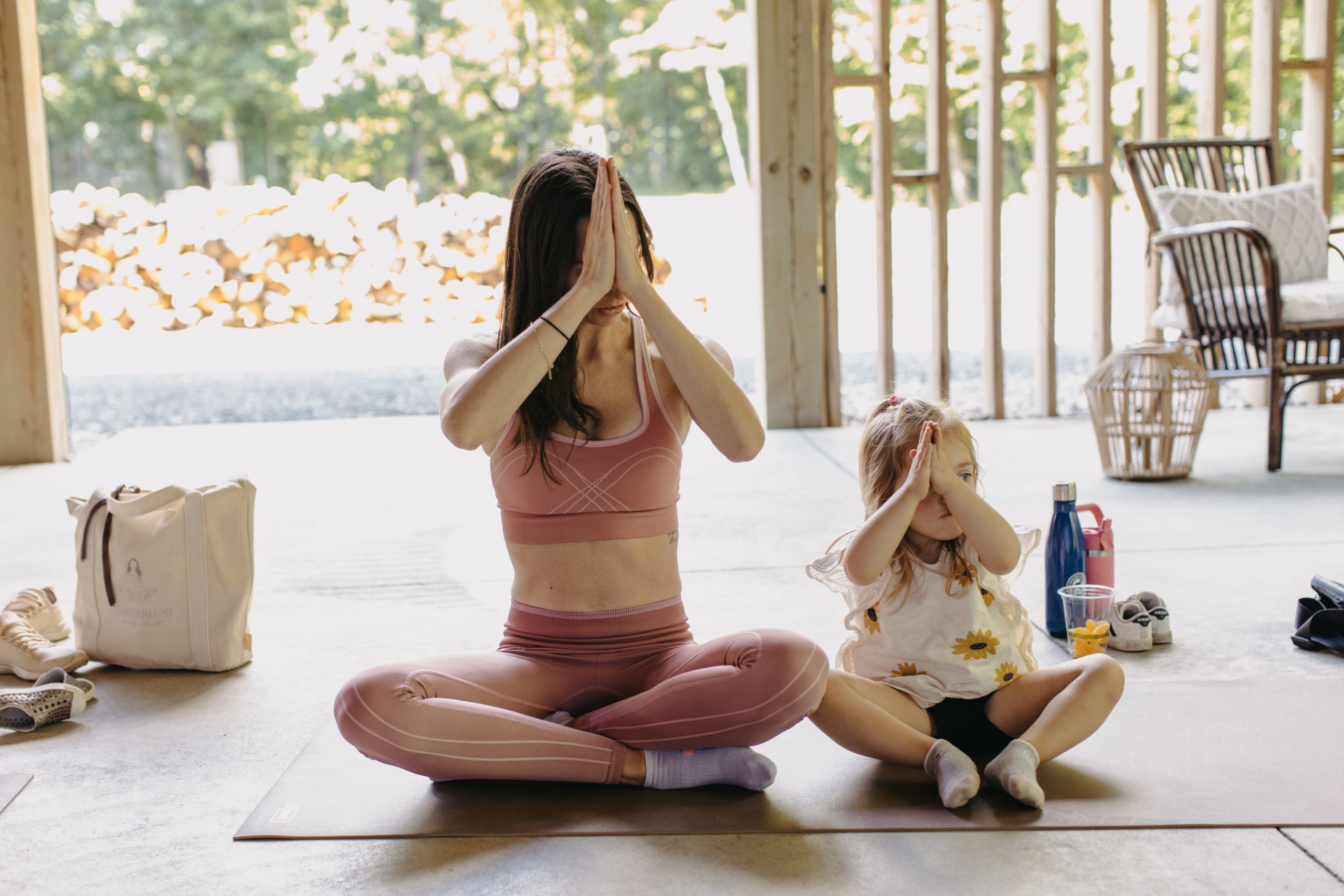 A mother and daughter doing yoga together.